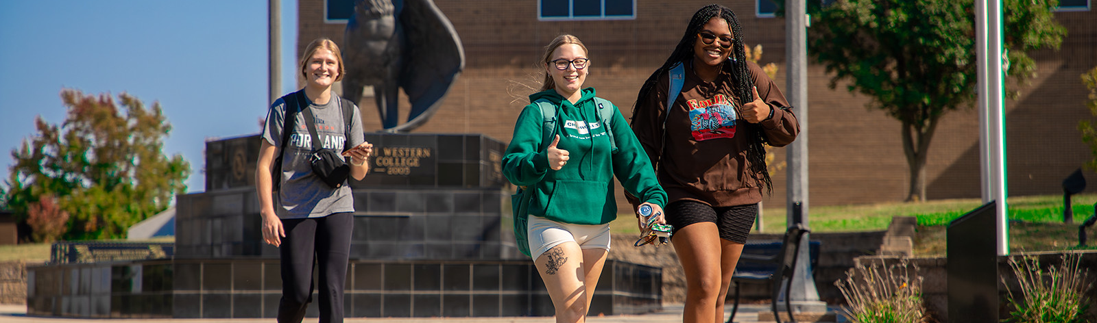 Students smiling as they walk on campus