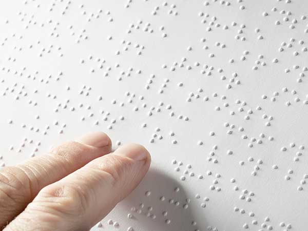 Person reading braille Person reading braille